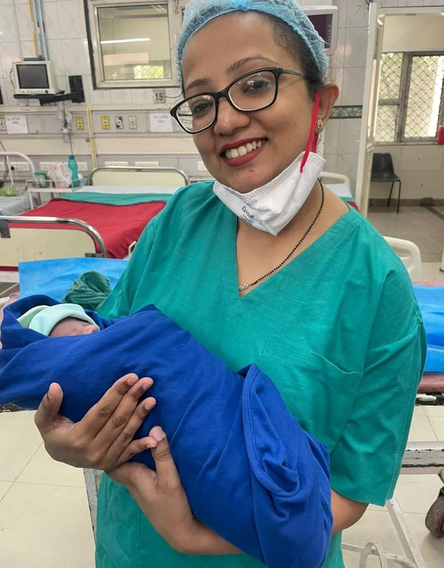Dr. Kriti Tiwari, IVF specialist in New Delhi, holding a newborn